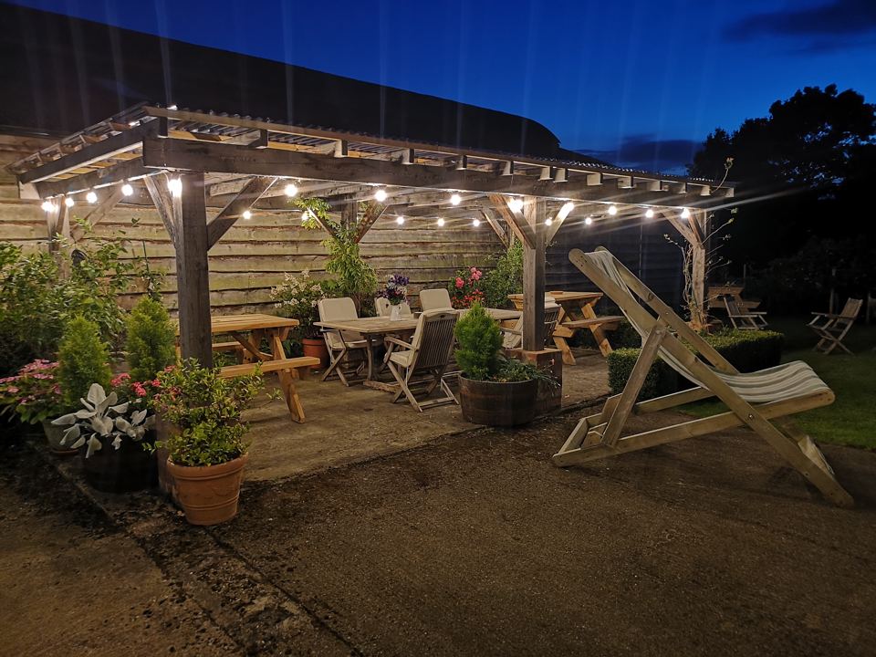 Covered dining area lit at dusk