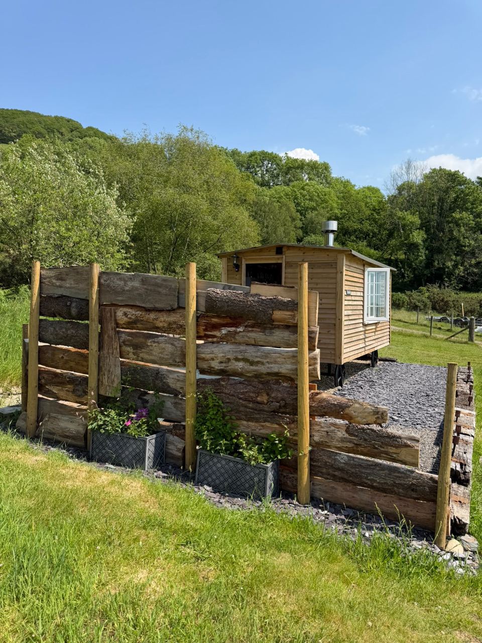 Hut behind a log fence