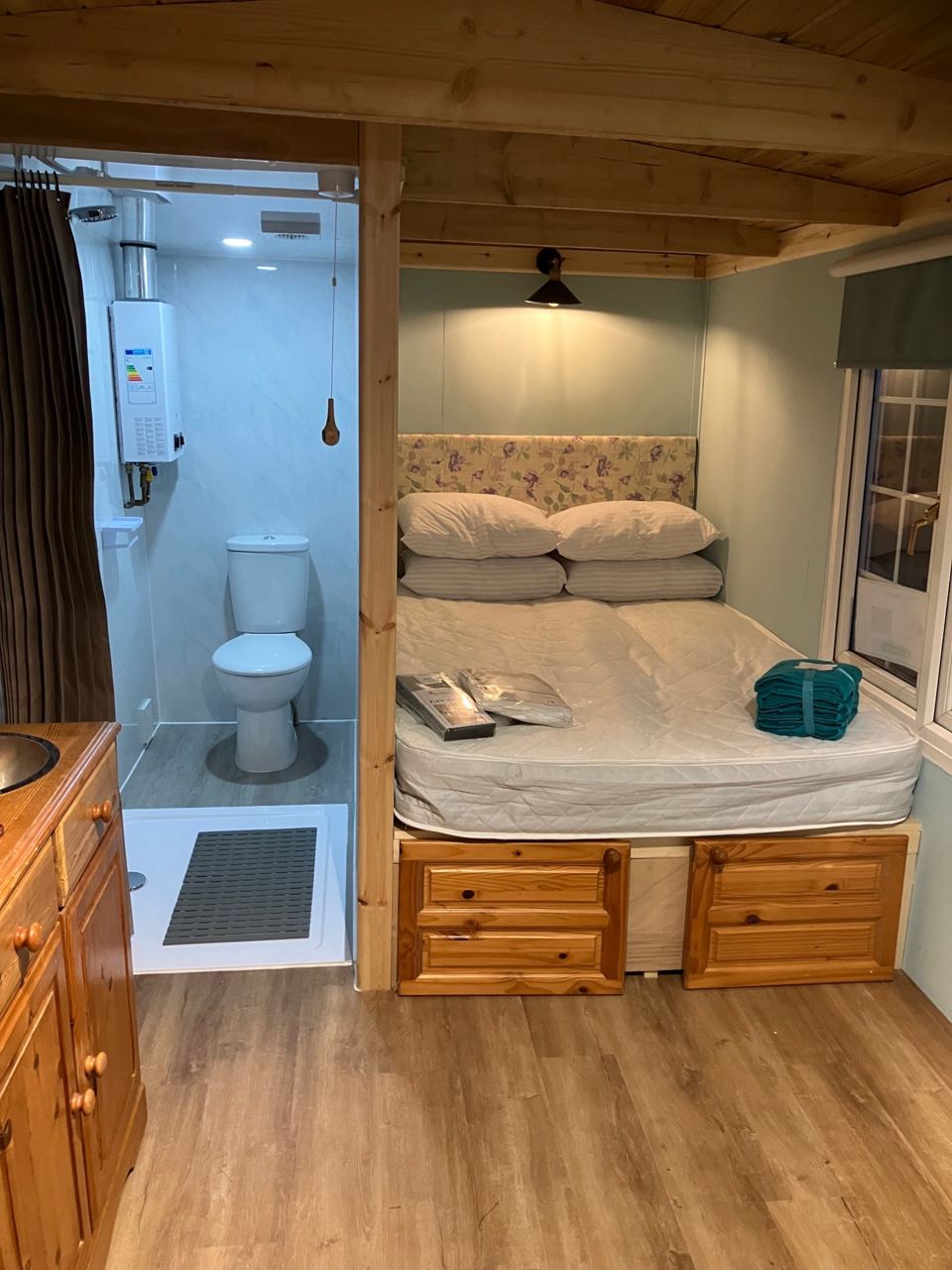 Hut interior with bed and shower