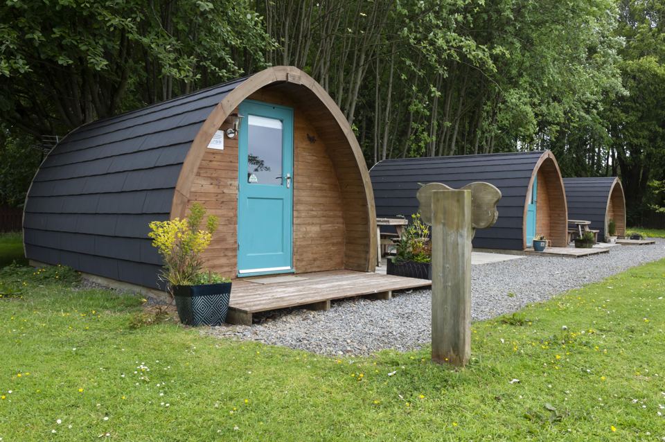 Glamping pods with teal doors