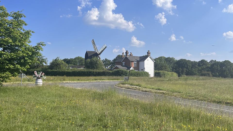 Grassy field with a windmill