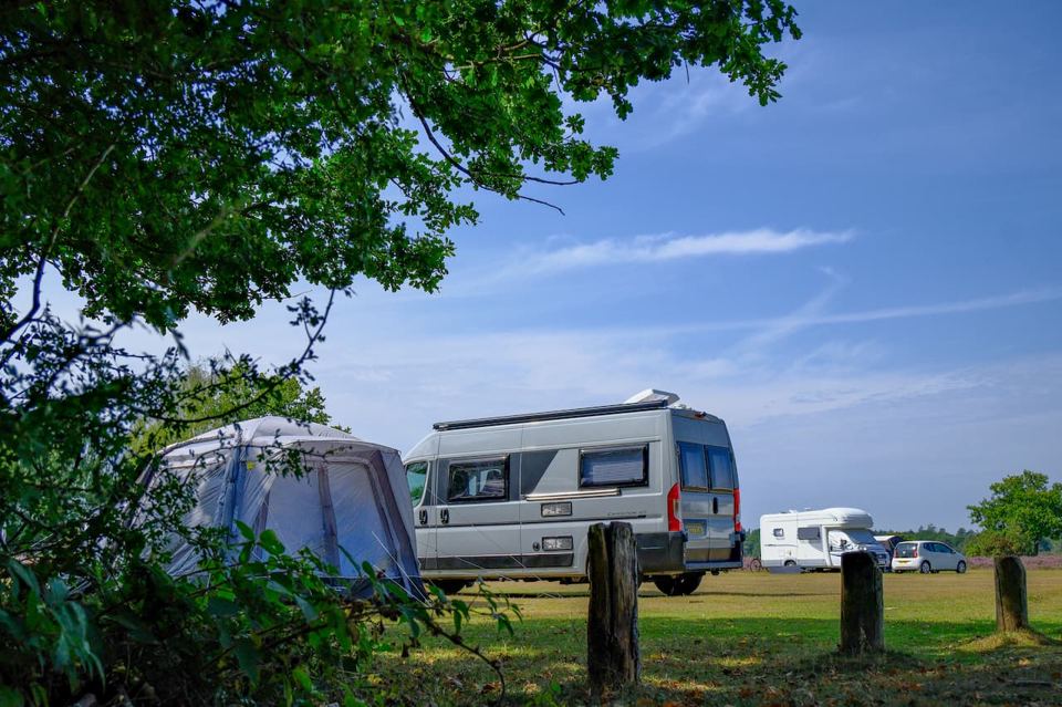 Campervan and tent on the grass