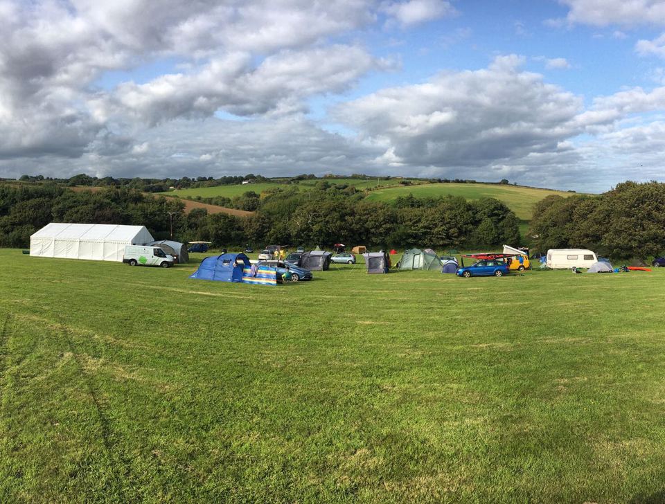 Grass field with tents and caravans