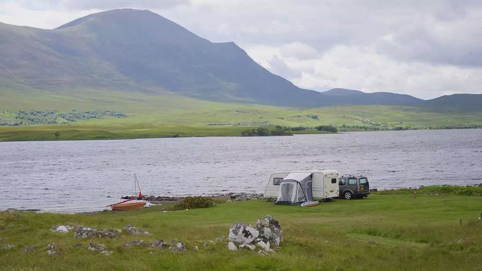 Awning pitched by the water