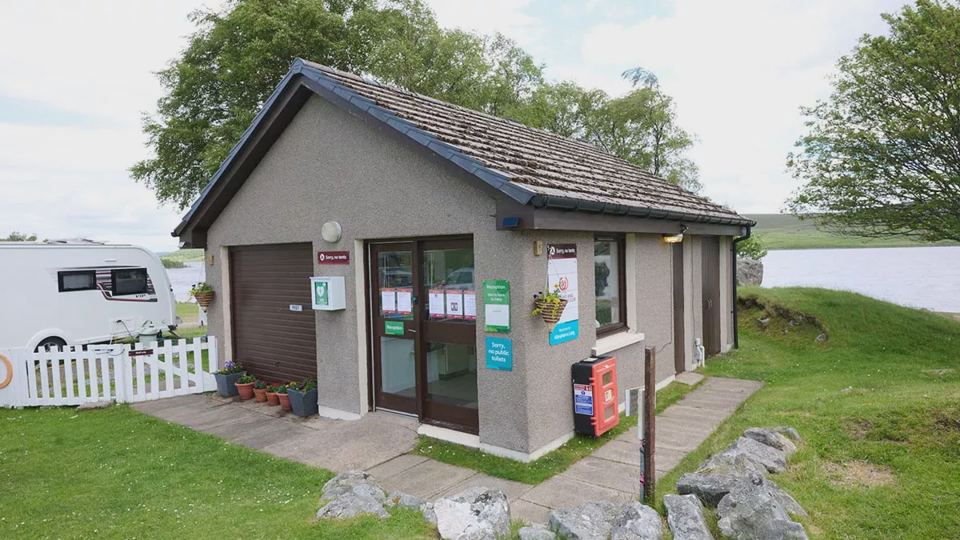 Site building by the loch