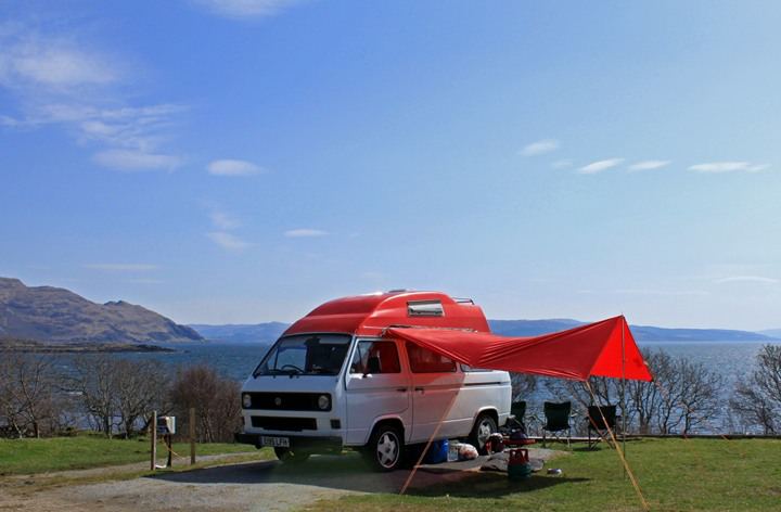 Campervan and awning facing the sea