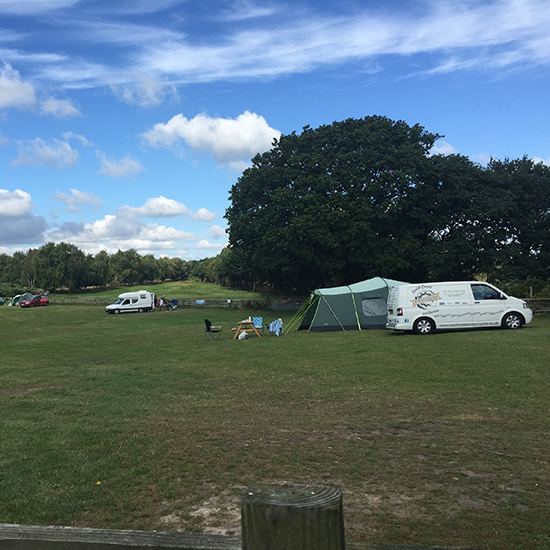 Campervan and tent on the field