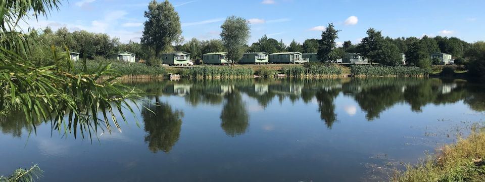 Lake with caravans beyond