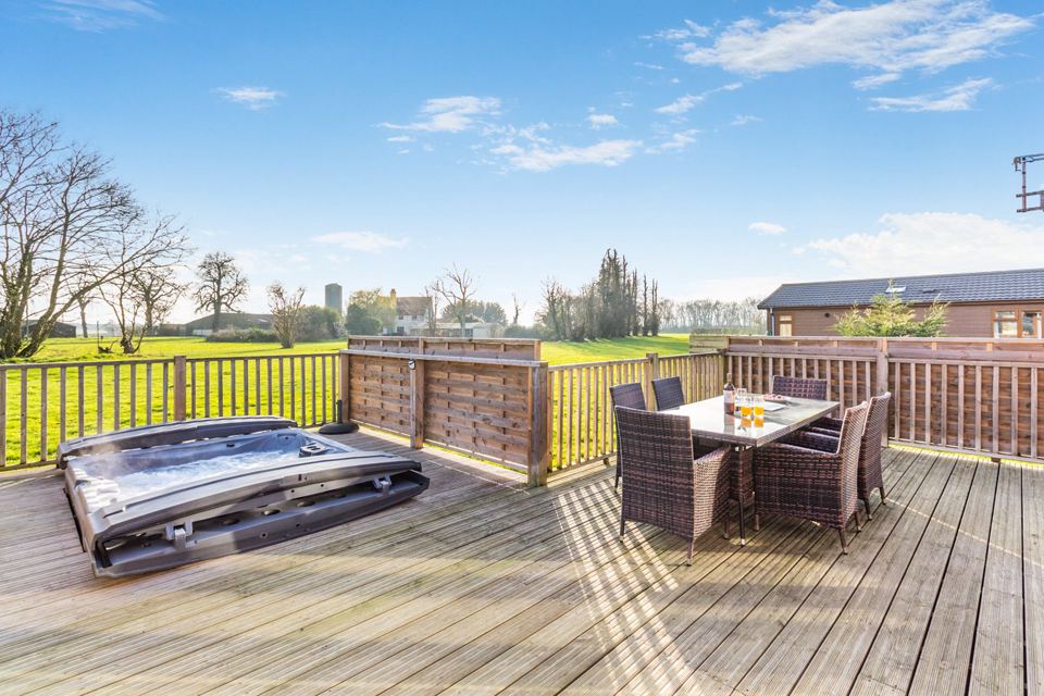 Veranda with hot tub and dining set