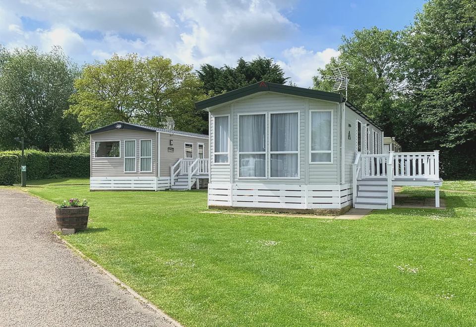 Caravans beside a hedge