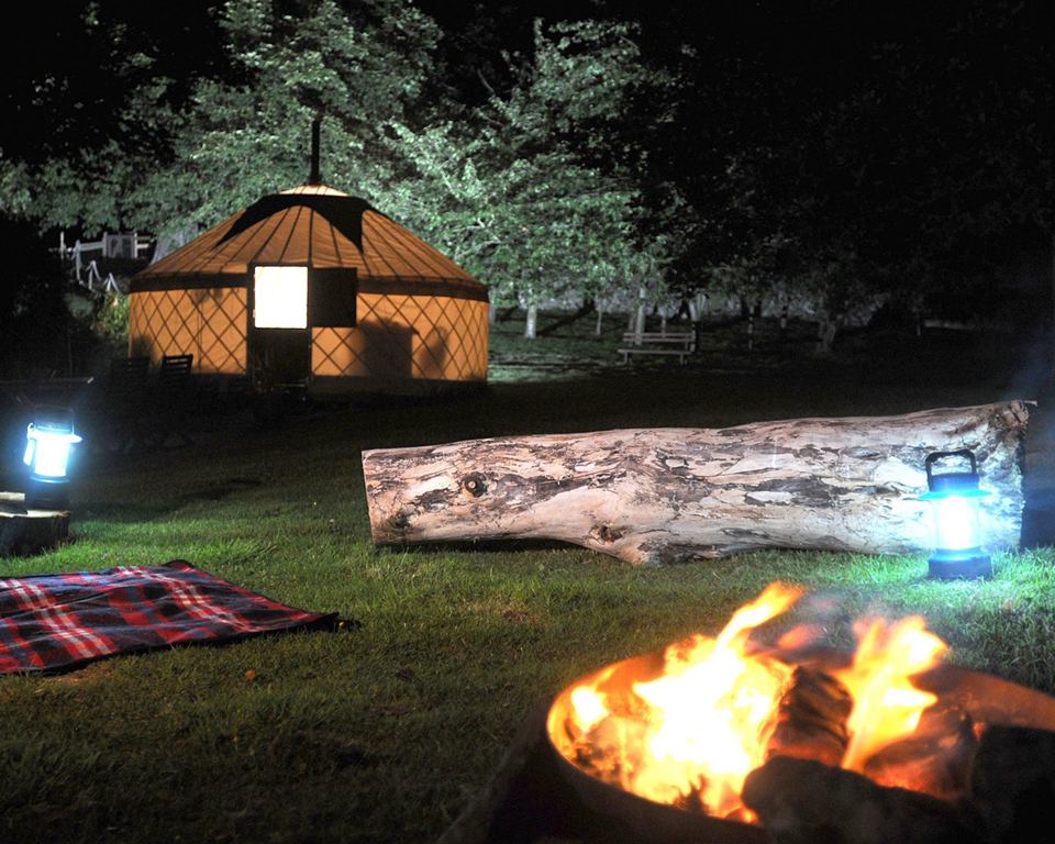Yurt and fire pit at night