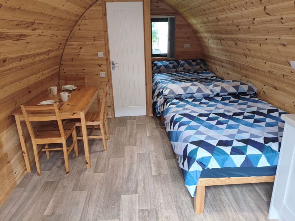 Beds and table inside a pod