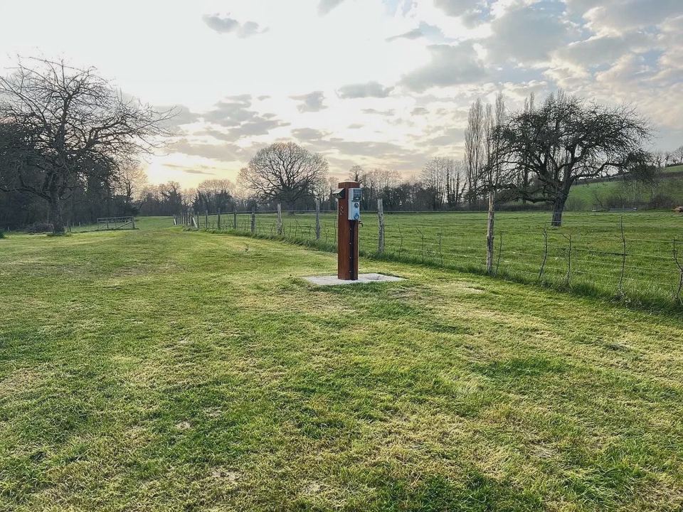 Open grass field with a post