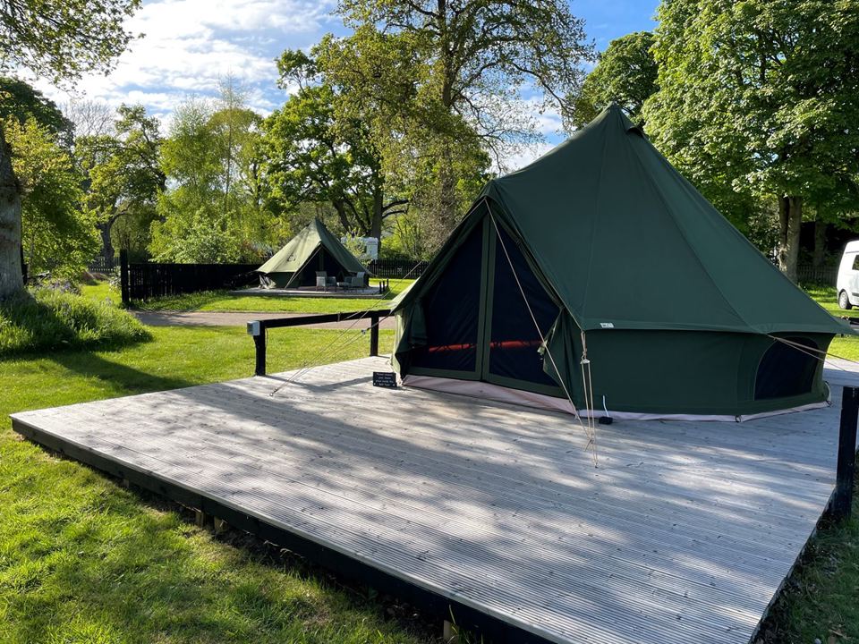 Green bell tent on a deck