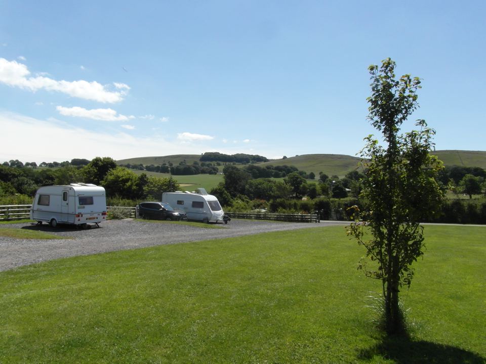 Caravans on hardstanding with hills
