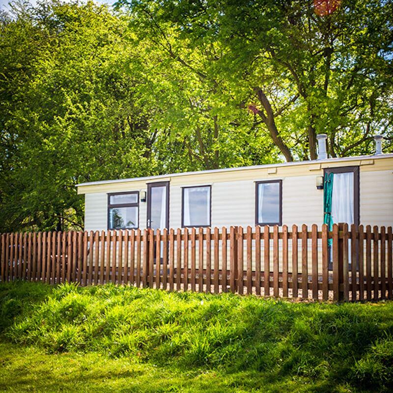 Static caravan behind a fence