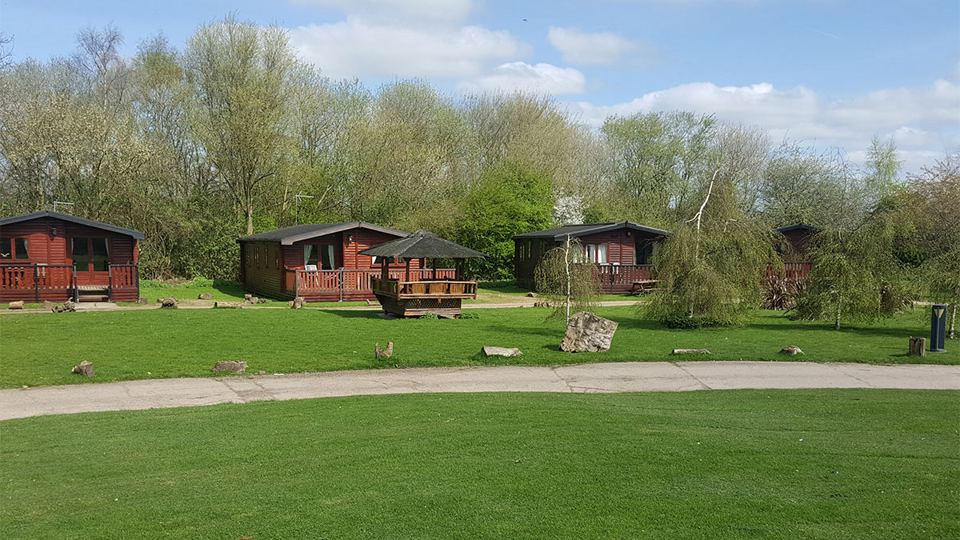 Log cabins across the grass
