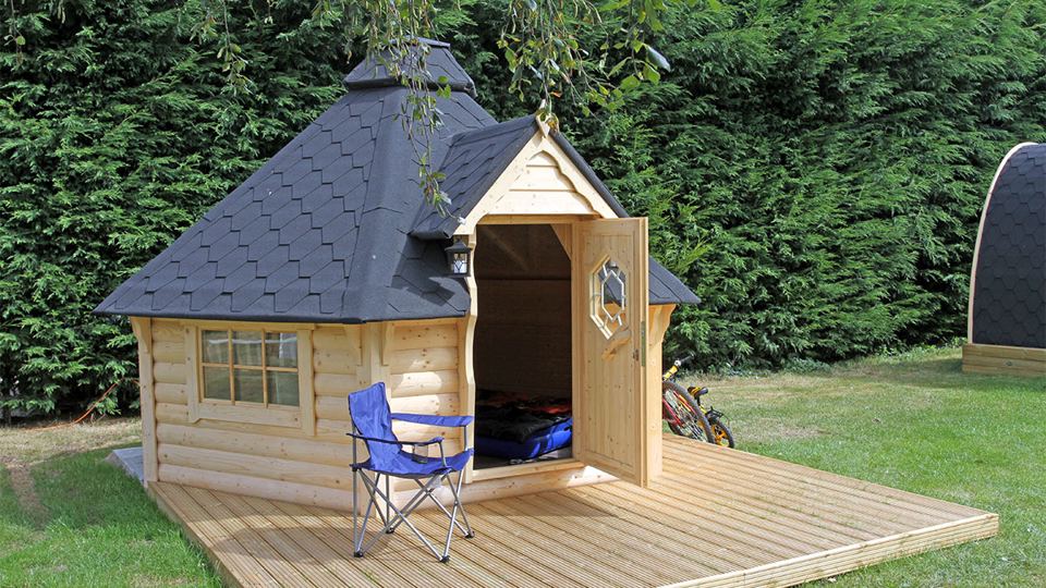Wooden glamping hut on a deck