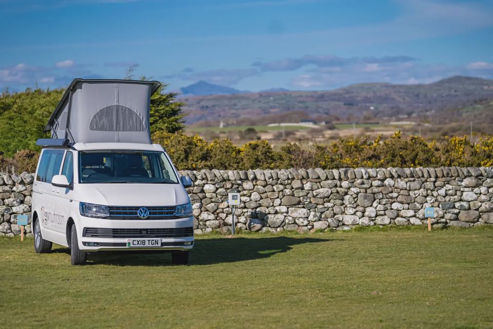 Campervan on grass with mountain view