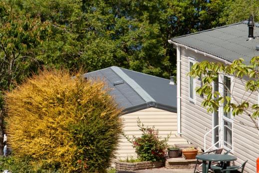 Static caravan among shrubs