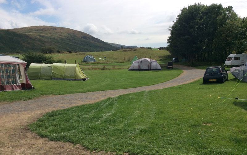 Grass pitches with tents and hills