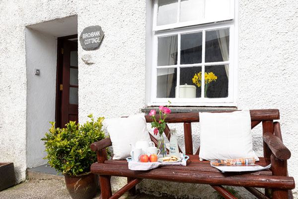 Cottage exterior with wooden bench