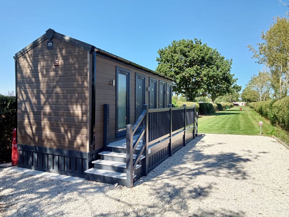 Timber-clad cabin by the lawn