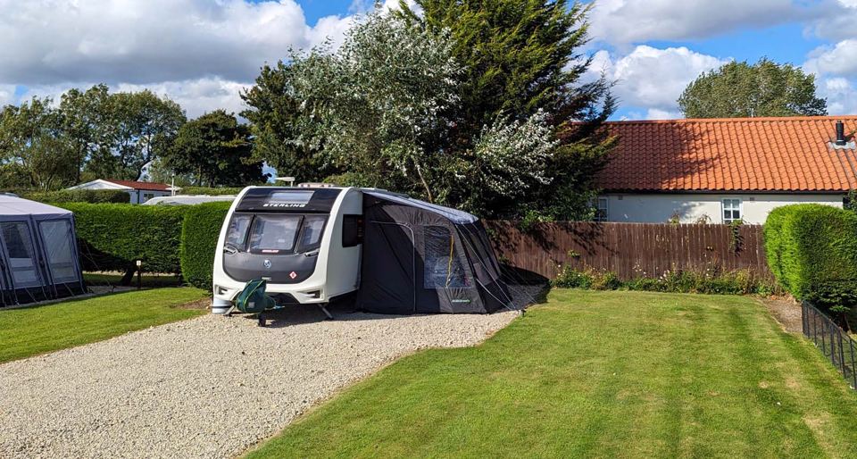 Hedged touring pitch with awning