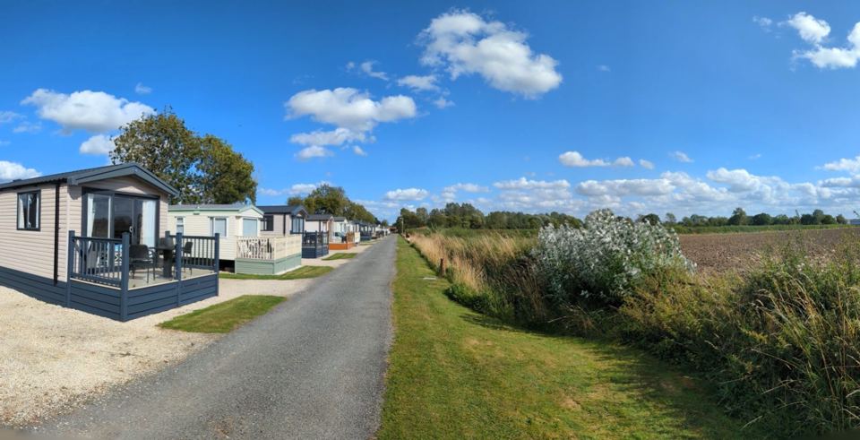 Holiday homes beside a field