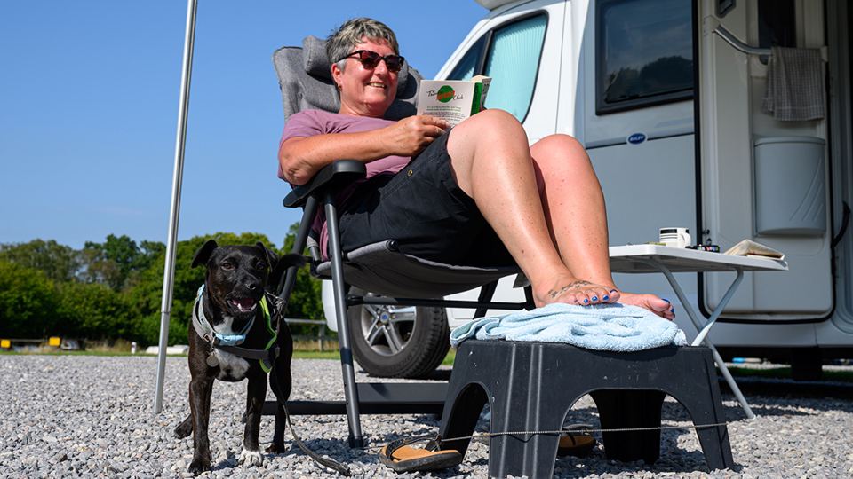 Relaxing by the motorhome with dog