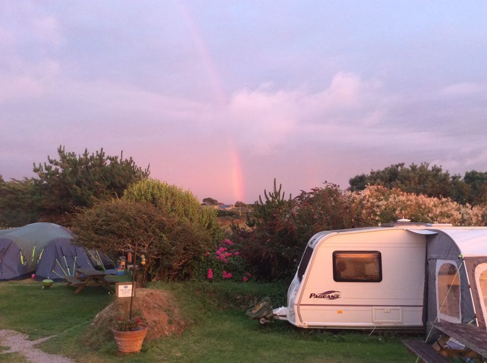 Pitches under a rainbow at dusk