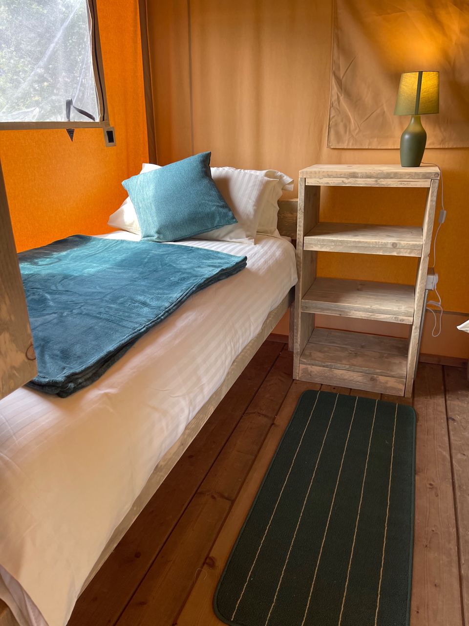 Bed inside the safari tent