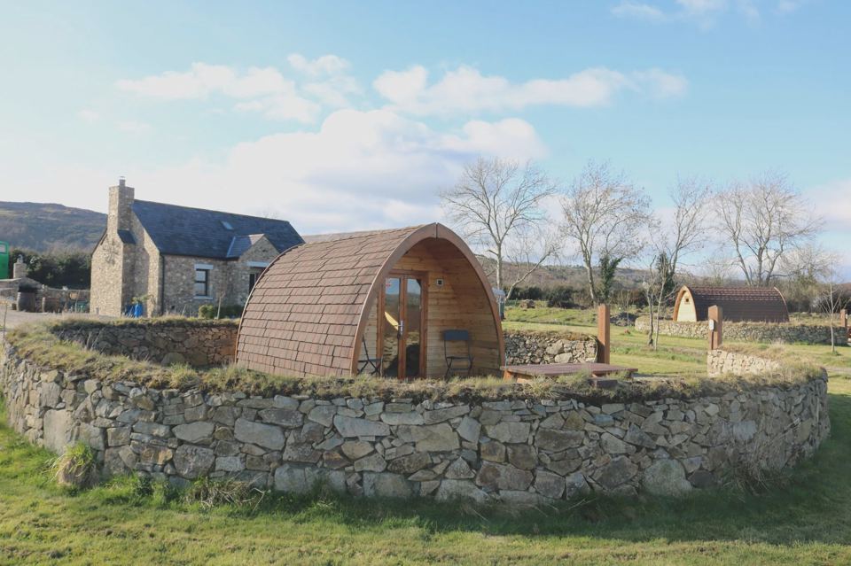 Wooden pod in a stone enclosure