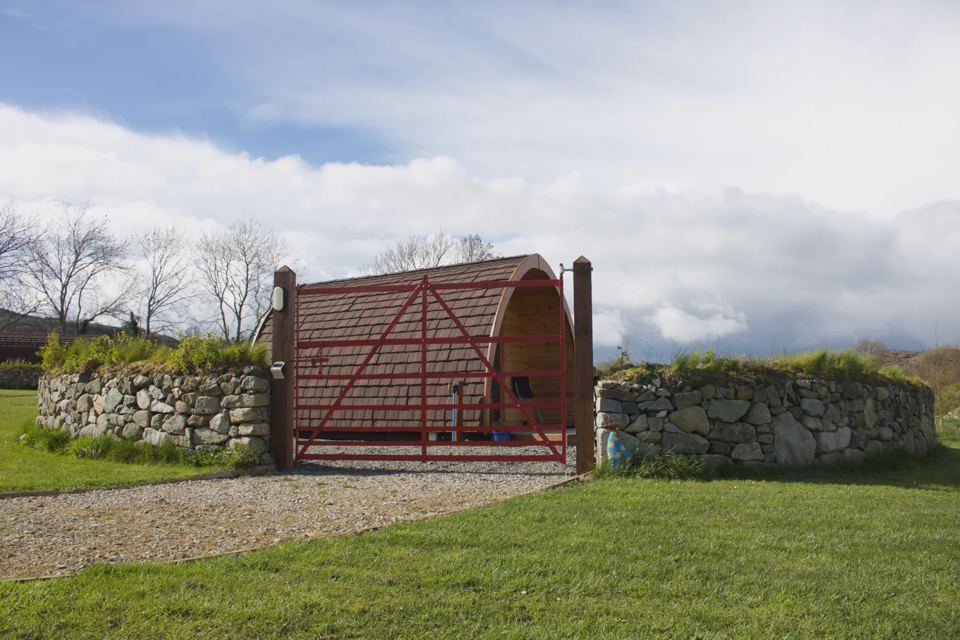 Pod behind a stone wall
