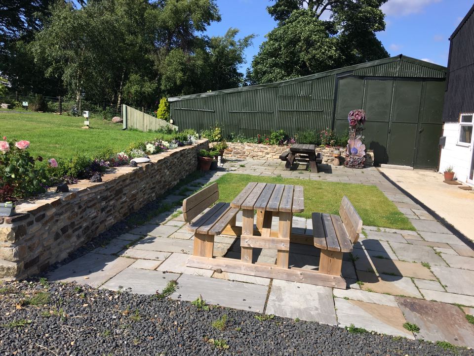 Patio seating by the farm buildings