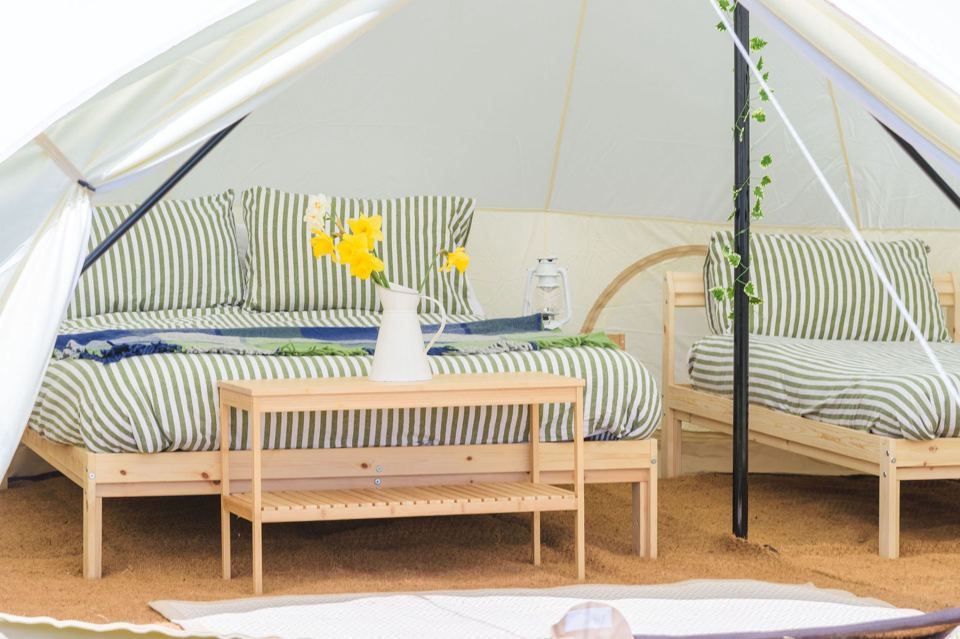 Inside a bell tent with twin beds