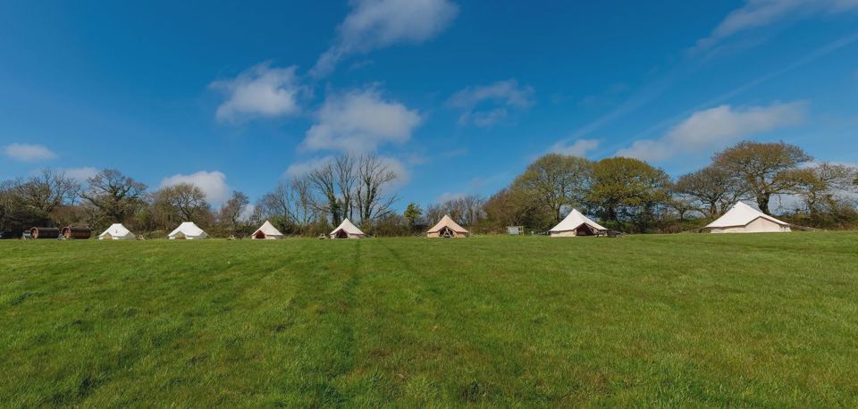 Bell tents across the grass field