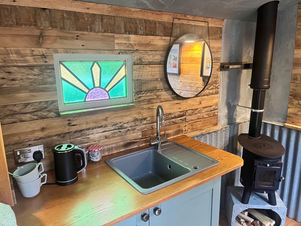 Kitchen with sink and wood stove