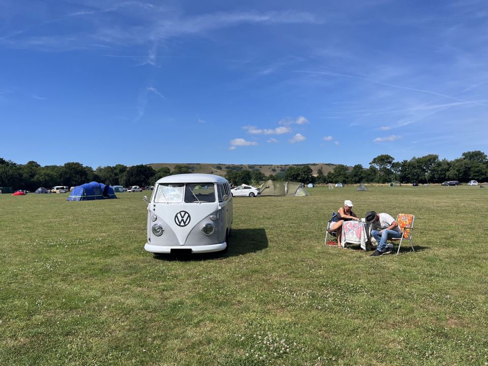 Camper and tents in the field