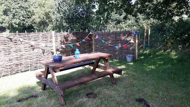 Picnic bench in a fenced pitch