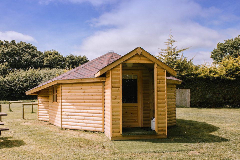 Timber cabin on the field