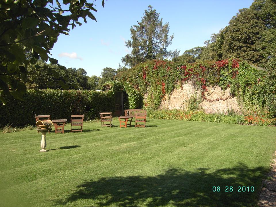 Lawn with seating and walled garden