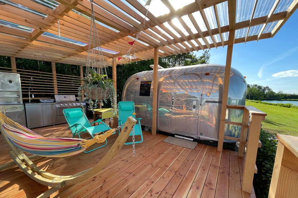 Airstream and deck by the lake