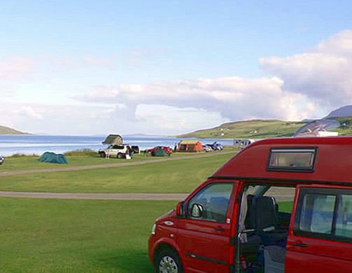 Tents and campervan facing the loch