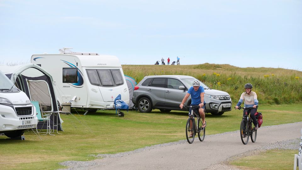 Cyclists passing the pitches