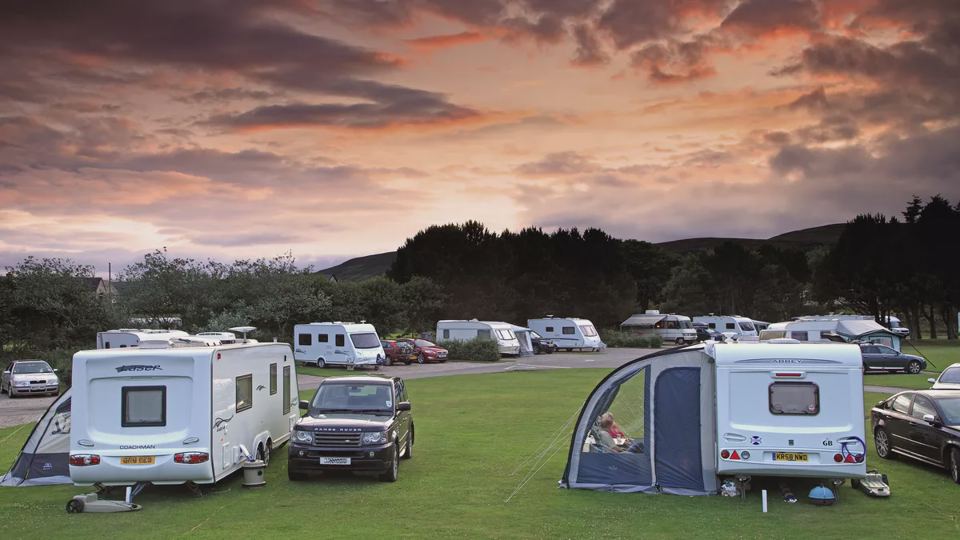 Caravans under an evening sky