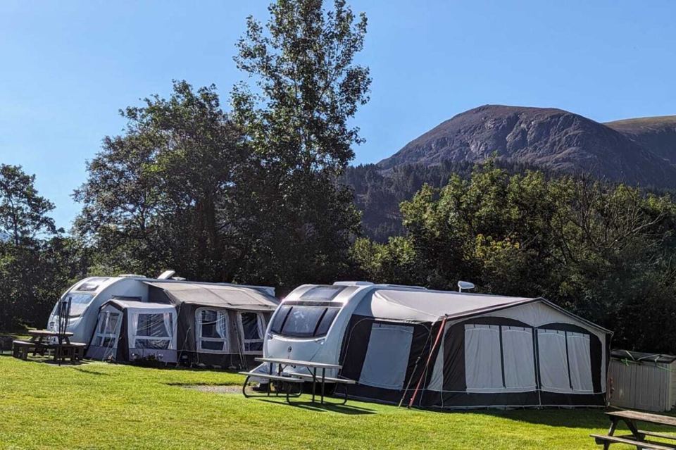 Touring caravans under the hillside