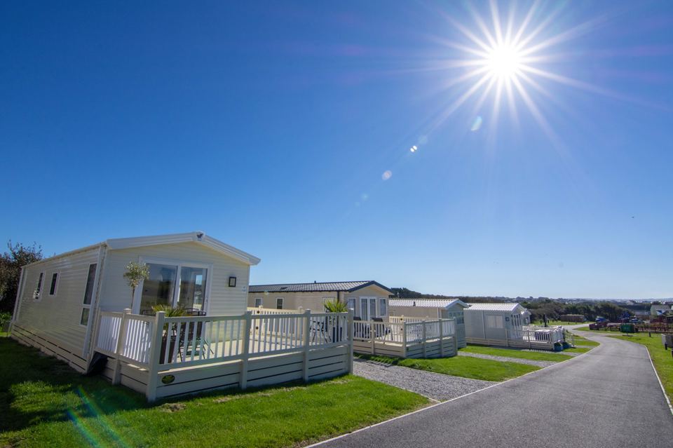 Static caravans on sunny road