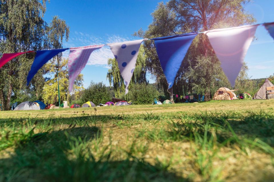 Open field with tents and bunting