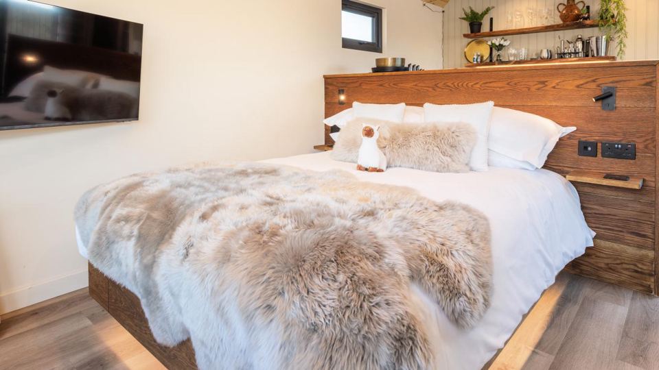 Pod bedroom with fur throw